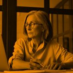 woman working in office; orange filter