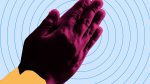 two purple hands clasped together on blue bullseye background